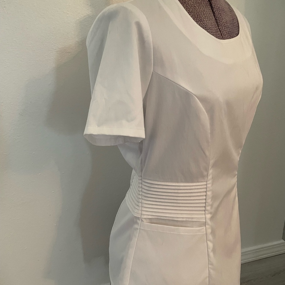 Jaanuu White Scrub Top with Slimming Pleats and Gold Side Zipper